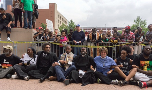 Activists, clergy and Dr. Cornell West lock arms in protest at federal building in St. Louis, MO, August 10. Photo: D.L. Phillips