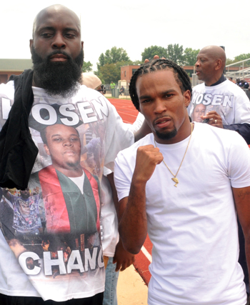 Michael Brown, Sr. (left) at event in Ferguson, Mo. with a supporter on the one year anniversary of his son’s killing. Photo: Cartan X Mosley